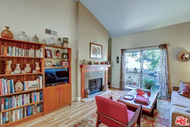 a living room with furniture a rug and a book shelf