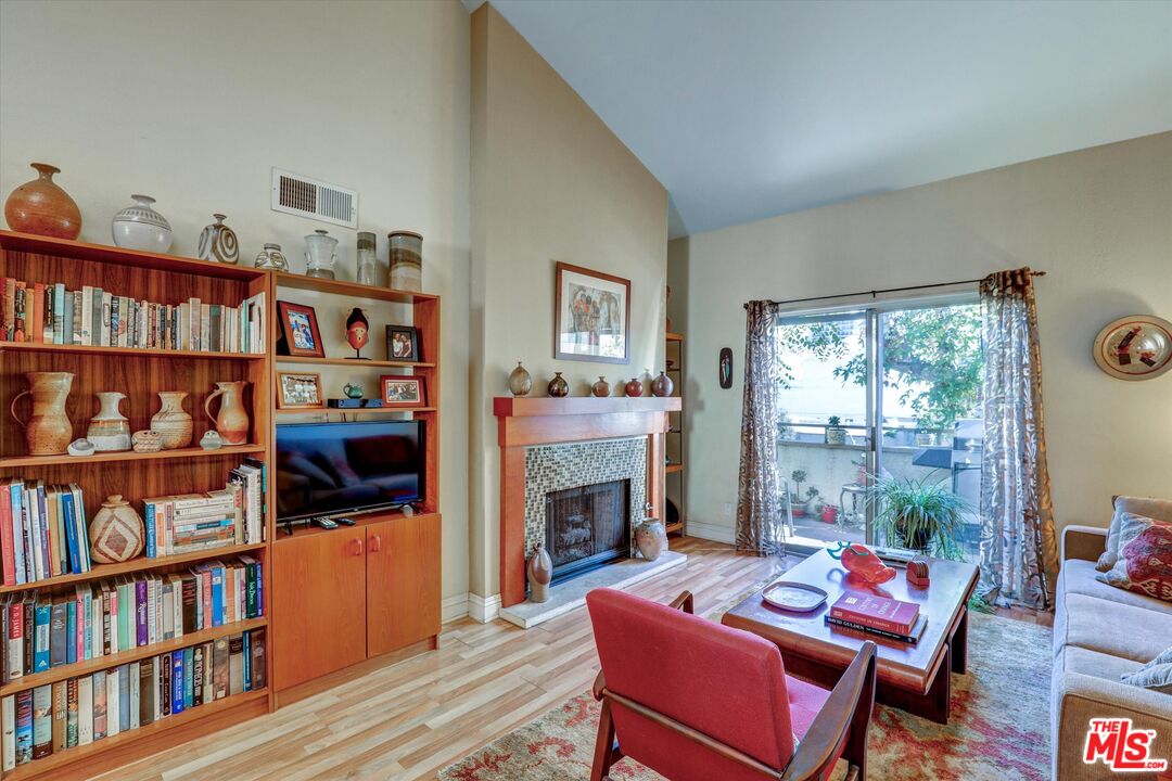 645 Chestnut Avenue, Unit 316 Long Beach, CA 90802 - Photo 7 of 24 a living room with furniture a rug and a book shelf
