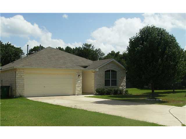 1408 Mathias Street Cedar Park, TX 78613 - Photo 1 of 1 a front view of a house with a garden and trees