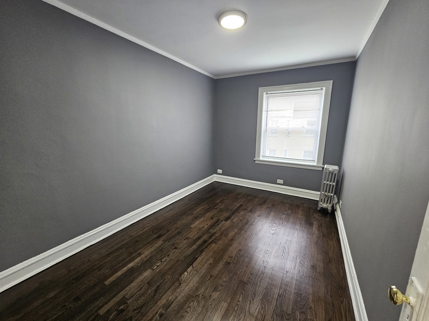 6551 North Francisco Avenue, Unit 3B Chicago, IL 60645 - Photo 13 of 15 an empty room with wooden floor and windows