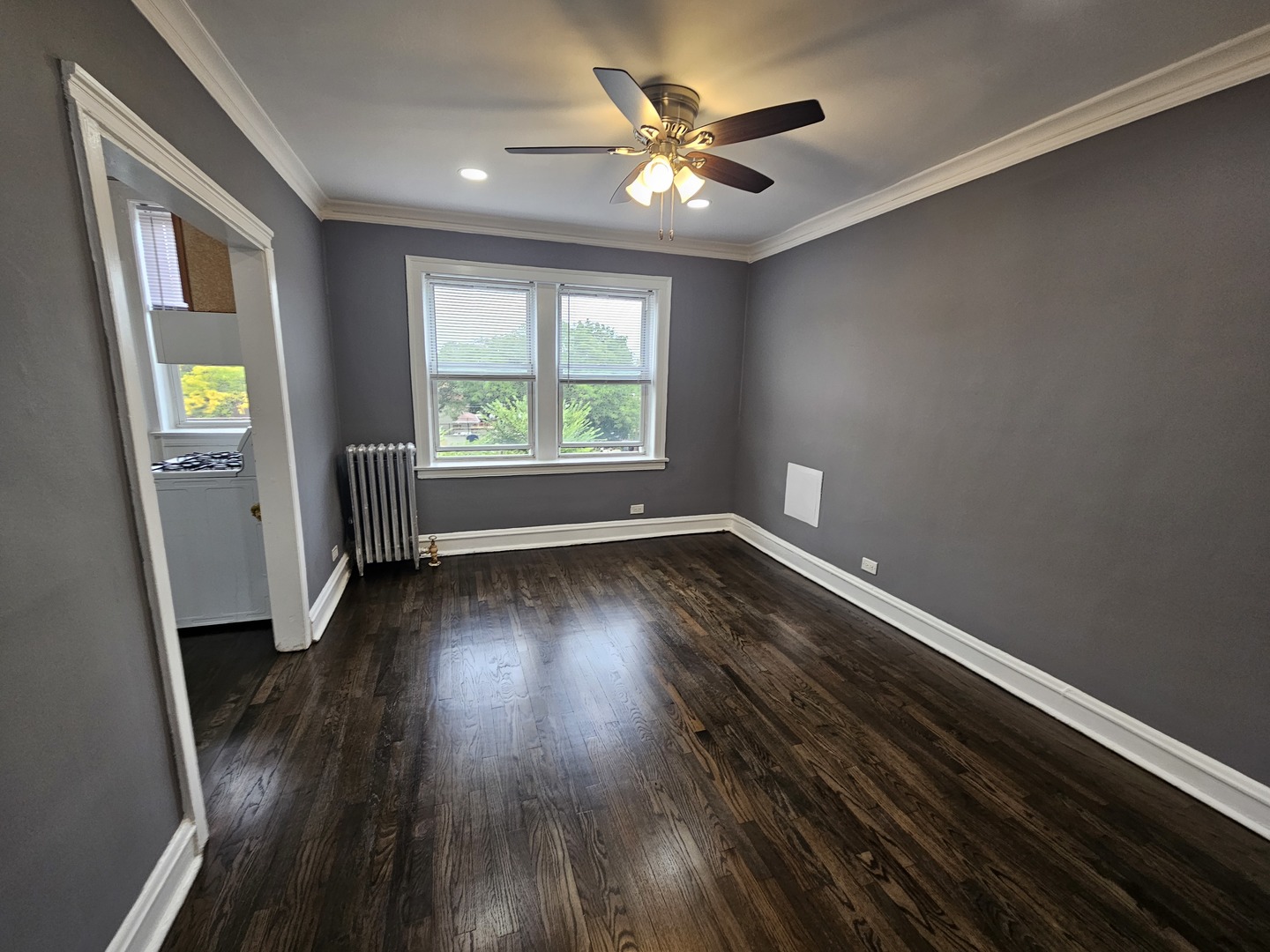 6551 North Francisco Avenue, Unit 3B Chicago, IL 60645 - Photo 6 of 15 an empty room with wooden floor and windows