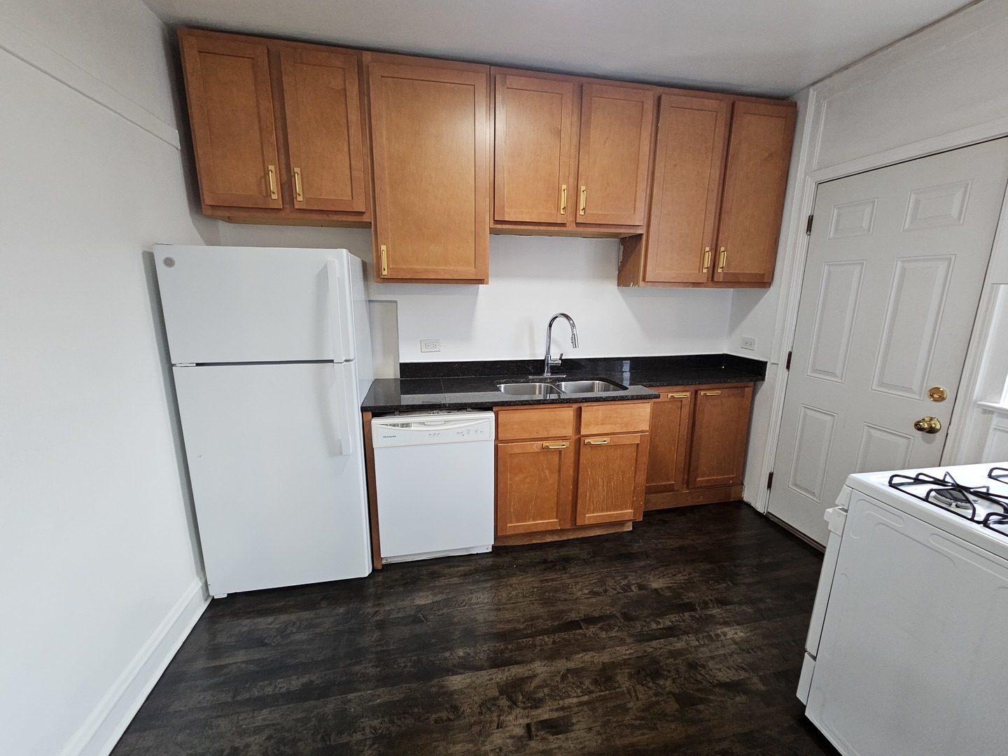 6551 North Francisco Avenue, Unit 3B Chicago, IL 60645 - Photo 8 of 15 a kitchen with a refrigerator sink and cabinets