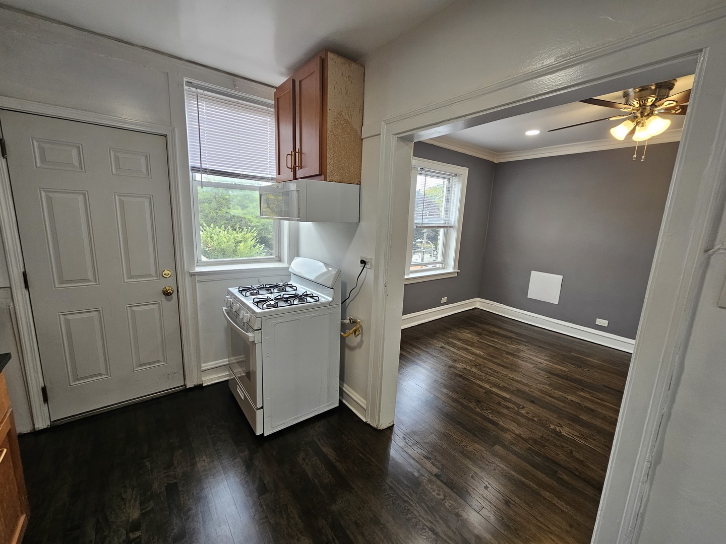 6551 North Francisco Avenue, Unit 3B Chicago, IL 60645 - Photo 10 of 15 a view of an empty room with wooden floor and a window
