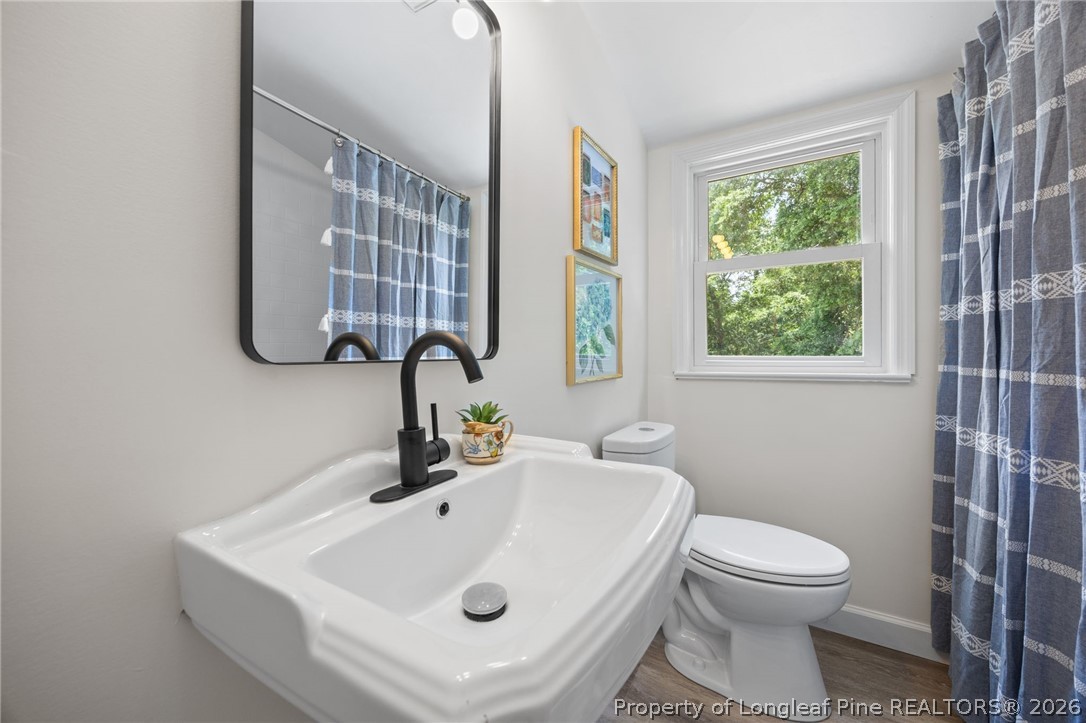 905 Riverside Boulevard Lumberton, NC 28358 - Photo 24 of 45 a bathroom with a sink a toilet and a window