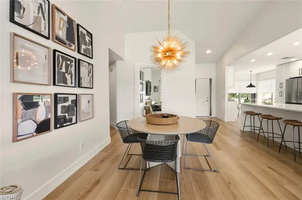 a view of a dining room with furniture and chandelier