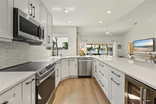 a kitchen with a sink stove and microwave