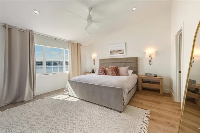 a bedroom with a large bed and a large window