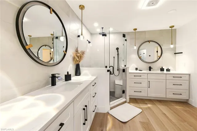 a spacious bathroom with a double vanity sink and a mirror