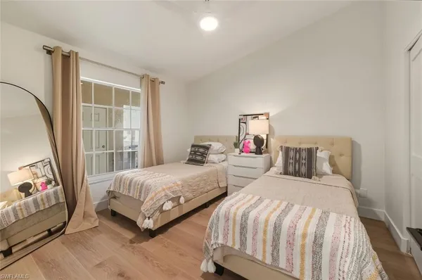a bedroom with two beds and a window