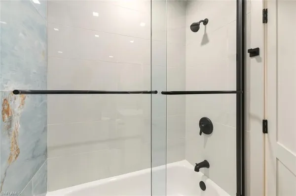 a bathroom with a shower and a mirror