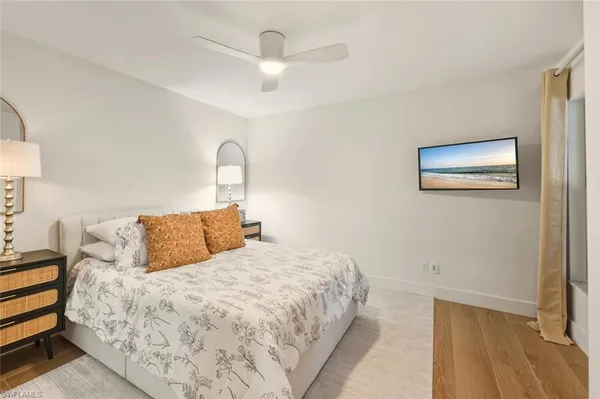 a bedroom with a bed and a painting on the wall