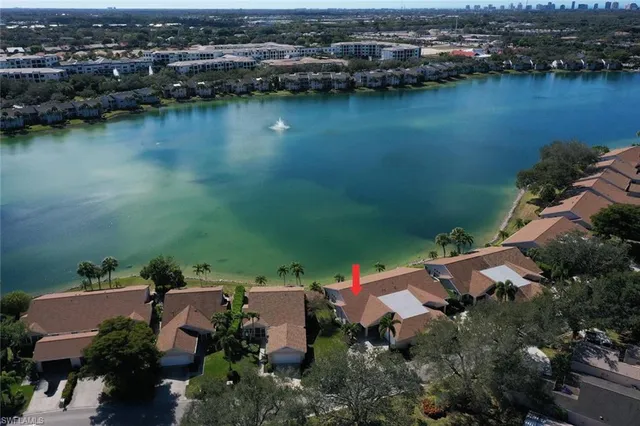 an aerial view of a house with a lake view