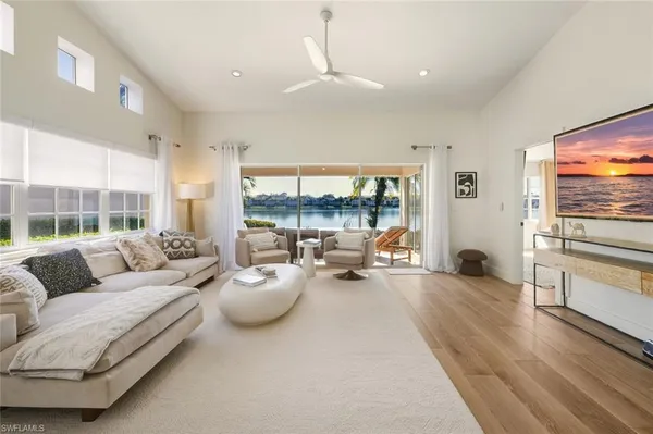 a living room with furniture and large windows