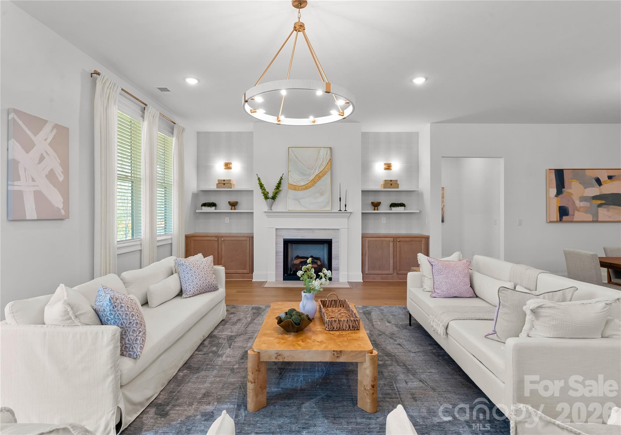 121 Vella Drive Locust, NC 28097 - Photo 18 of 46 a living room with furniture a fireplace and a chandelier
