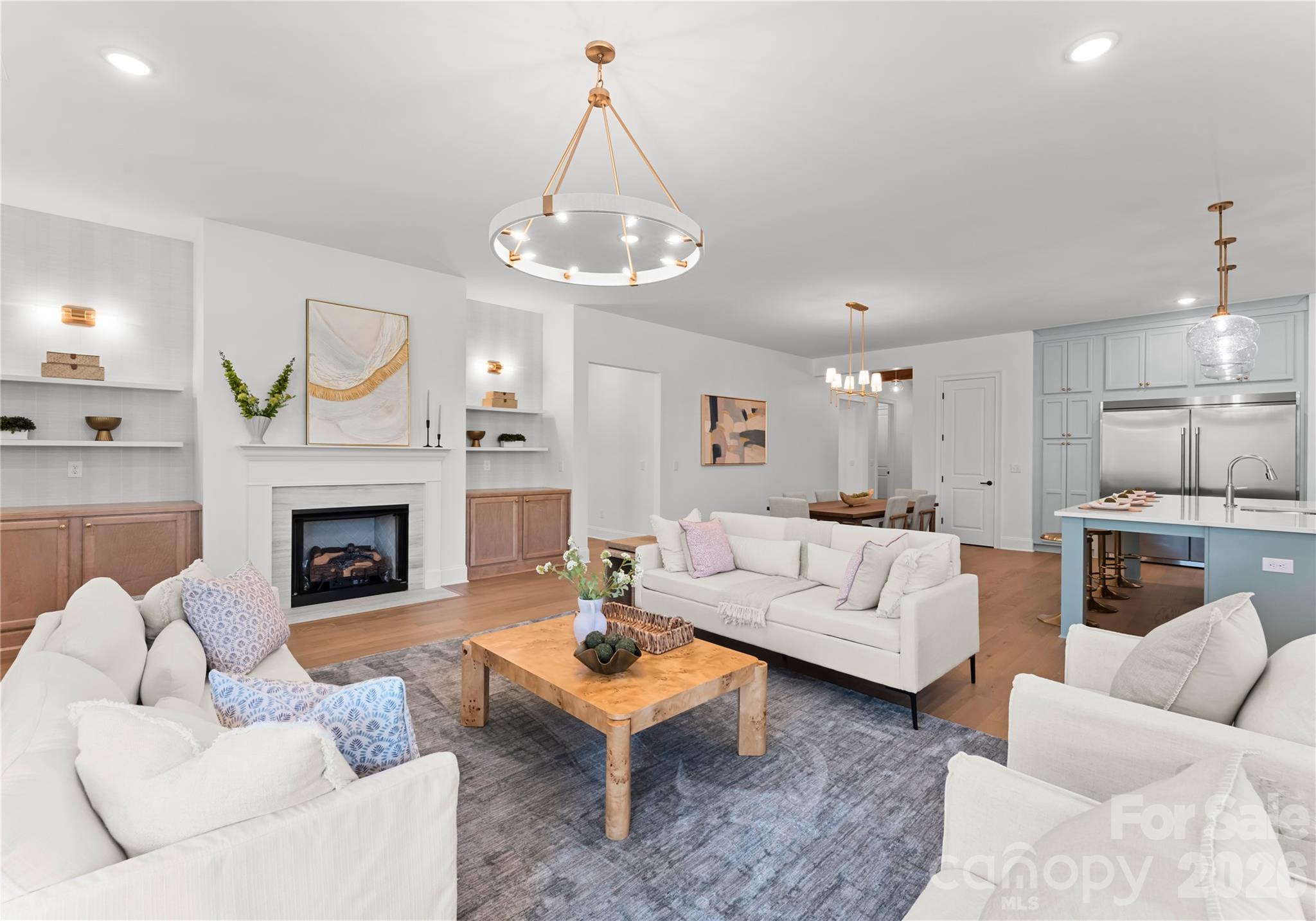 121 Vella Drive Locust, NC 28097 - Photo 22 of 46 a living room with furniture a fireplace and a chandelier