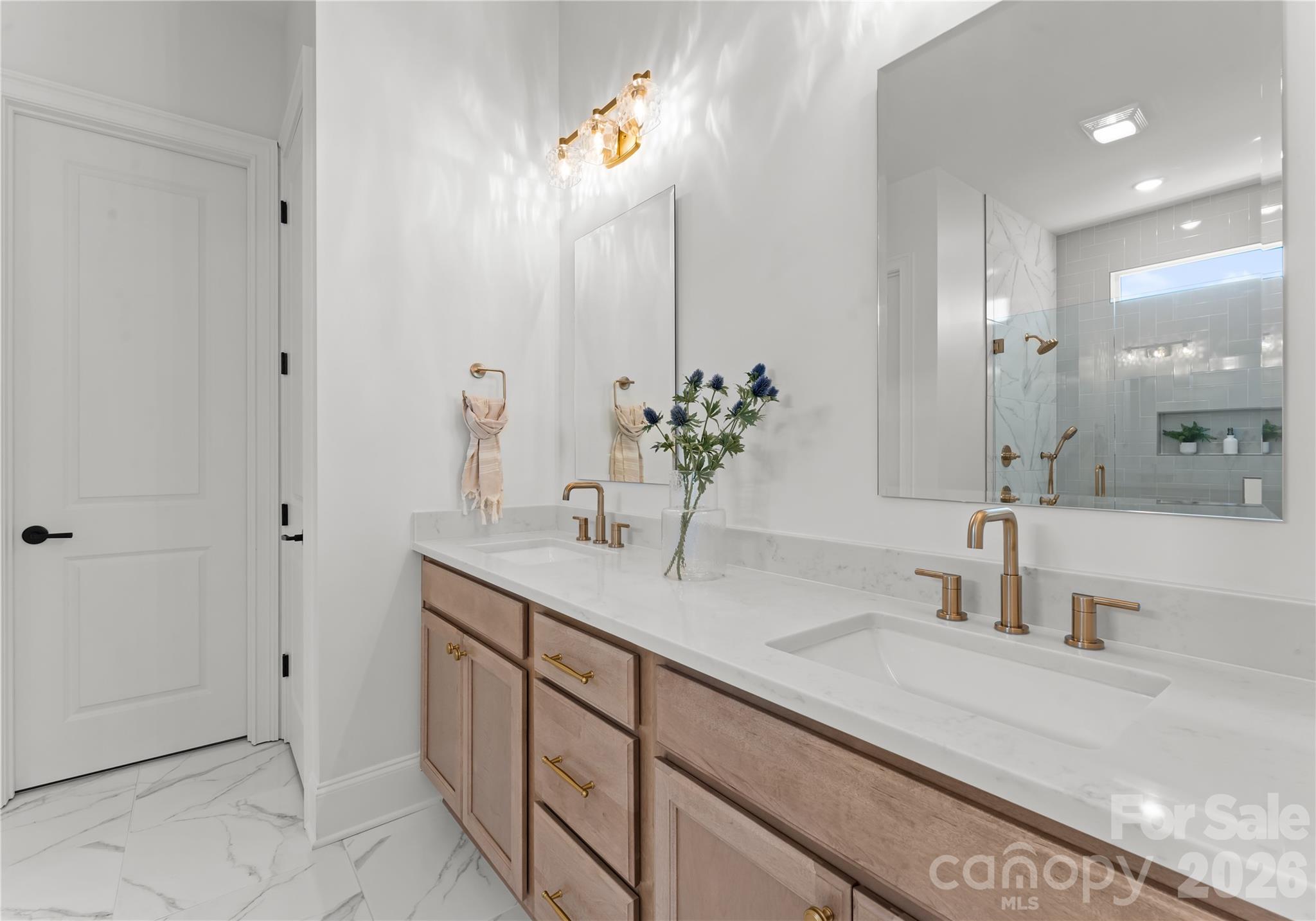 121 Vella Drive Locust, NC 28097 - Photo 26 of 46 a bathroom with a double vanity sink and a mirror