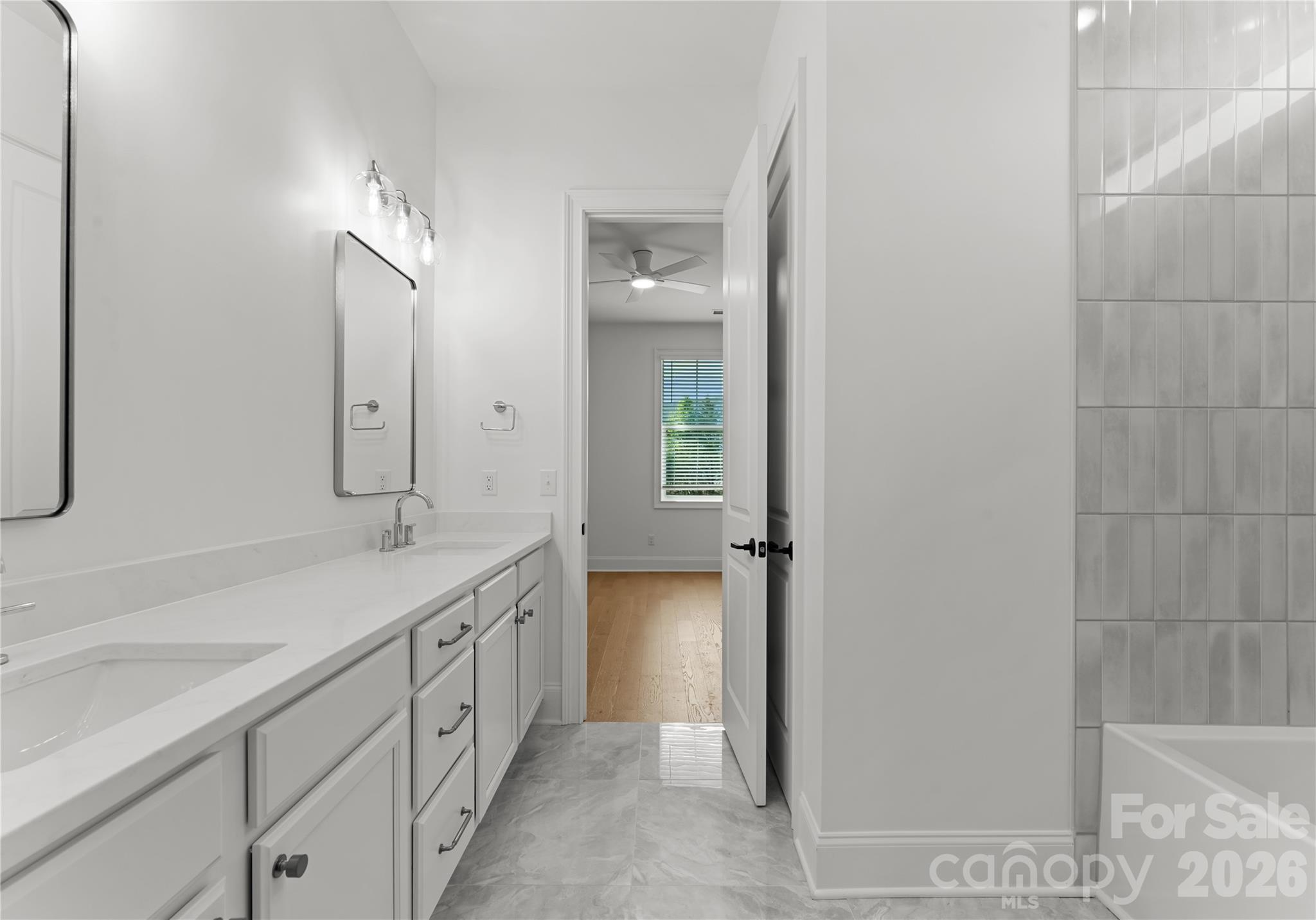 121 Vella Drive Locust, NC 28097 - Photo 32 of 46 a bathroom with a double vanity sink and a mirror