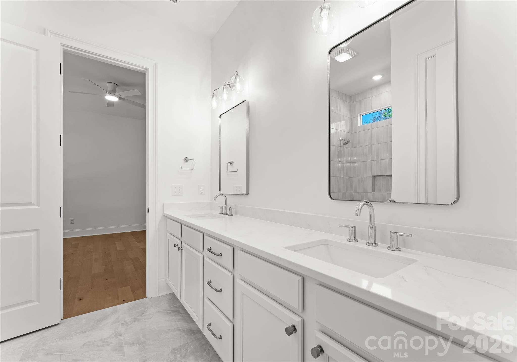 121 Vella Drive Locust, NC 28097 - Photo 33 of 46 a spacious bathroom with double sink and a large mirror