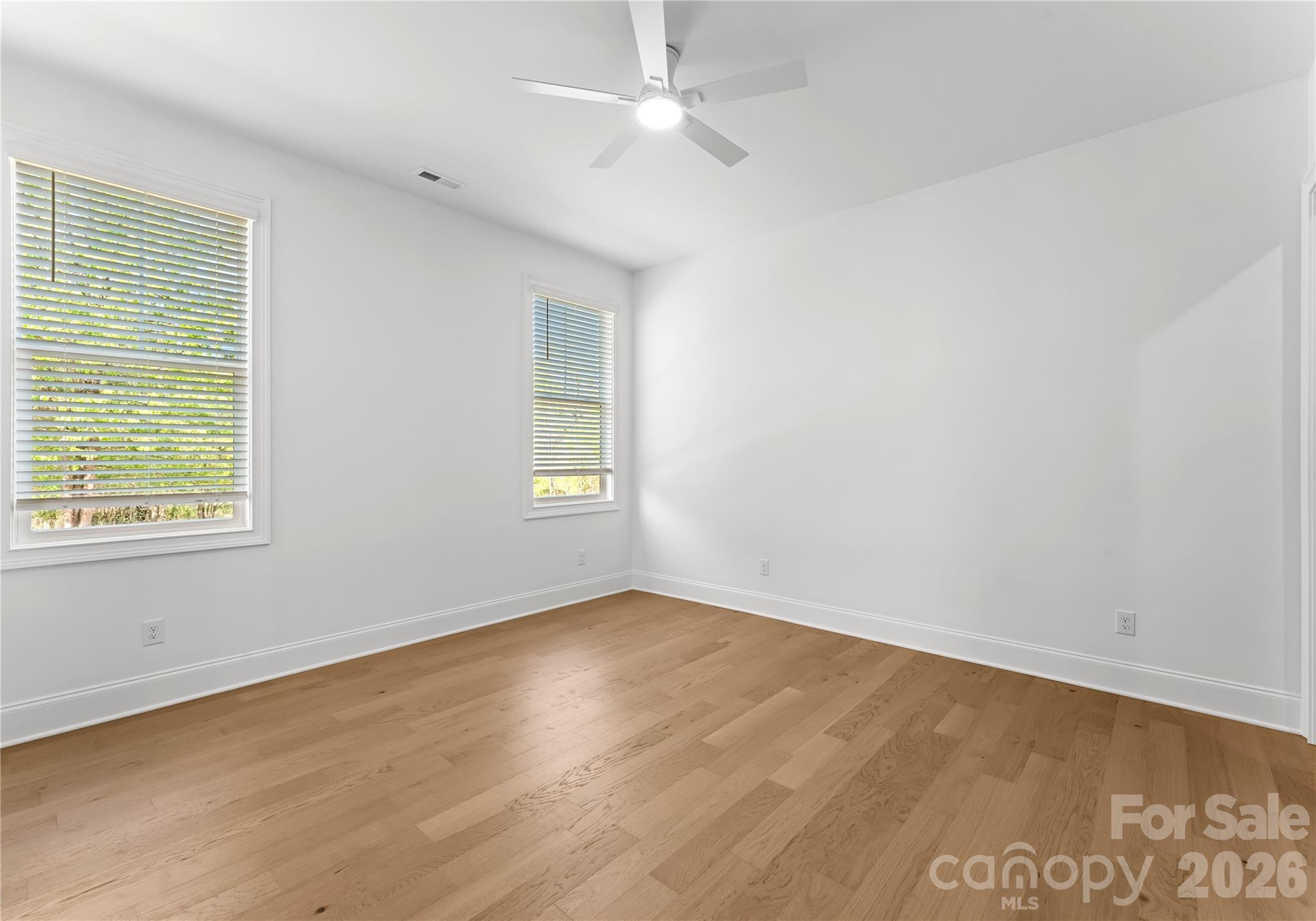 121 Vella Drive Locust, NC 28097 - Photo 40 of 46 an empty room with a window and wooden floor