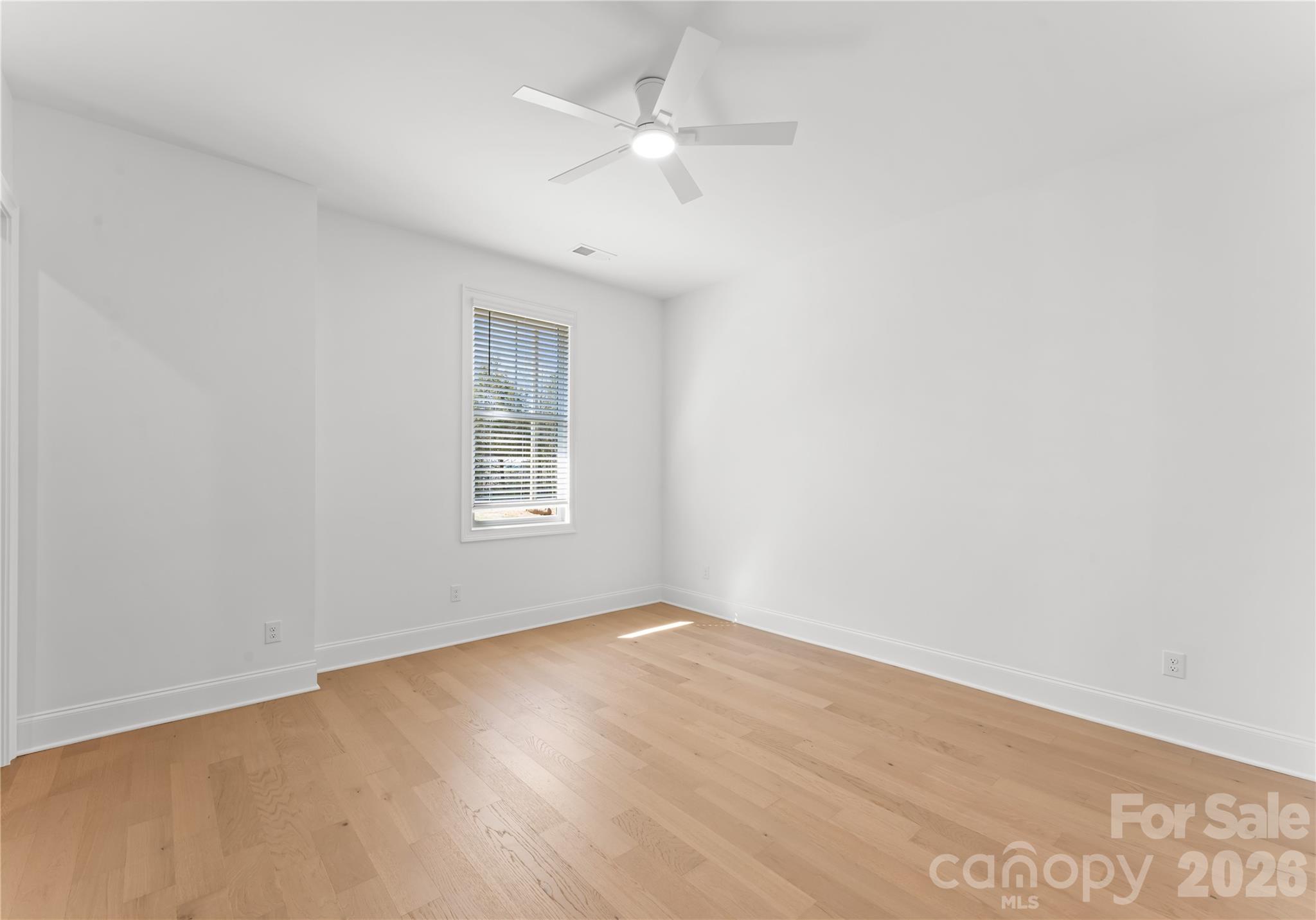 121 Vella Drive Locust, NC 28097 - Photo 41 of 46 an empty room with a window and a fan