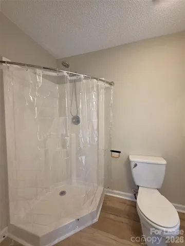 a white toilet sitting next to a shower
