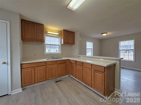 a kitchen with sink cabinets and wooden floor