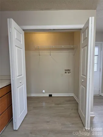 a view of a room with wooden floor