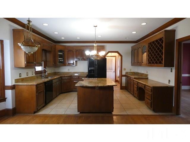 11705 Old Creedmoor Road Raleigh, NC 27613 - Photo 21 of 33 a kitchen with a sink stainless steel appliances and cabinets