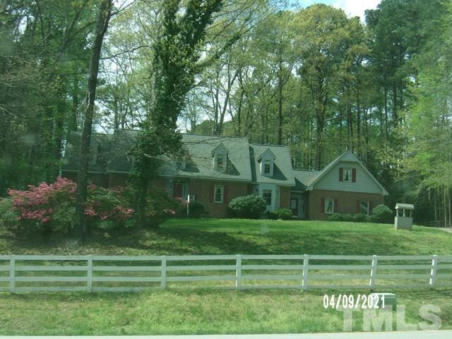 11705 Old Creedmoor Road Raleigh, NC 27613 - Photo 6 of 33 a front view of a house with a yard