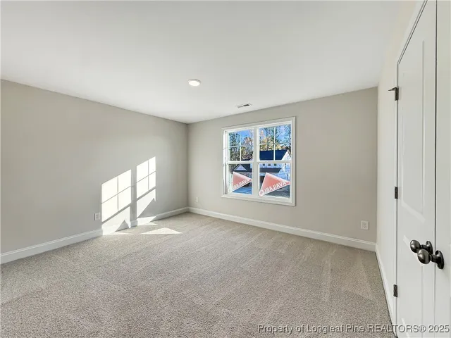 an empty room with windows and entrance