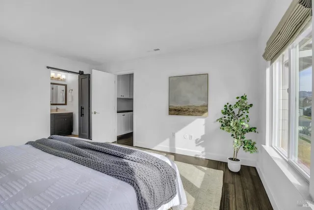 a bedroom with a bed and a potted plant