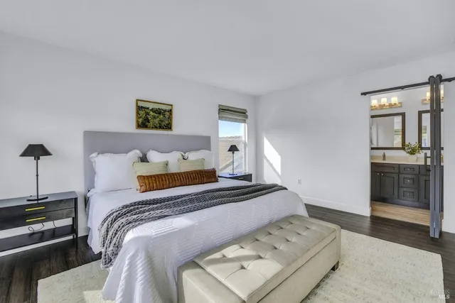 a bedroom with a bed and a night stand