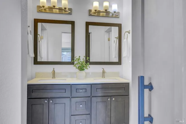a bathroom with a double vanity sink and a mirror