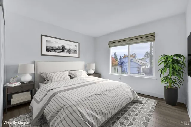 a bedroom with a bed and a painting on the wall