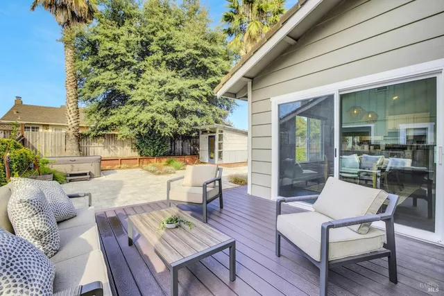 a view of a patio with couches table and chairs and potted plants