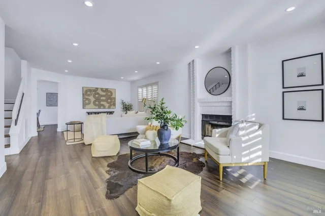 a living room with furniture a clock and a fireplace