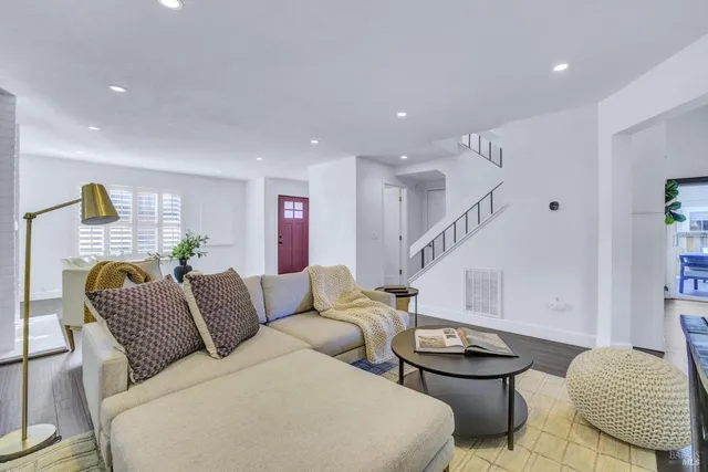 a living room with furniture and a chair
