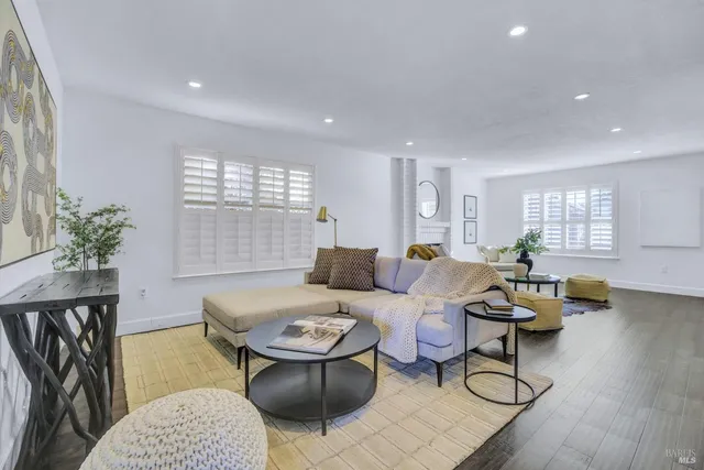 a living room with furniture a window and a table