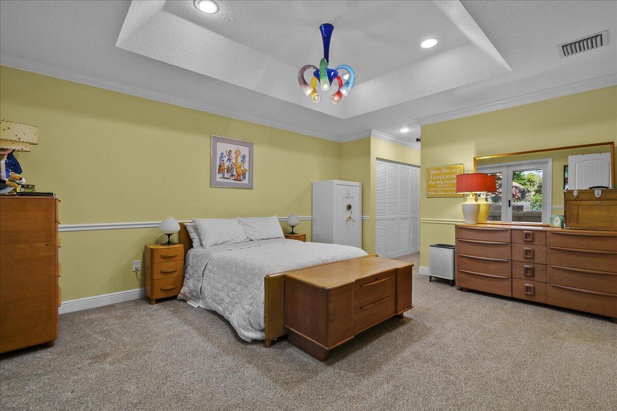 10975 Randolph Siding Road Jupiter, FL 33478 - Photo 35 of 97 a bed room with a bed and a dresser