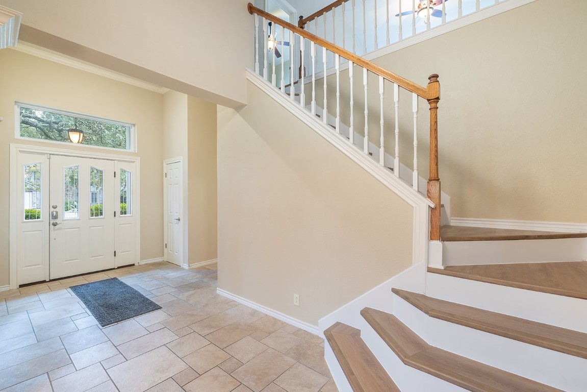 8514 Racine Trail Austin, TX 78717 - Photo 12 of 33 Entrance foyer with a high ceiling, stairs, and ornamental molding