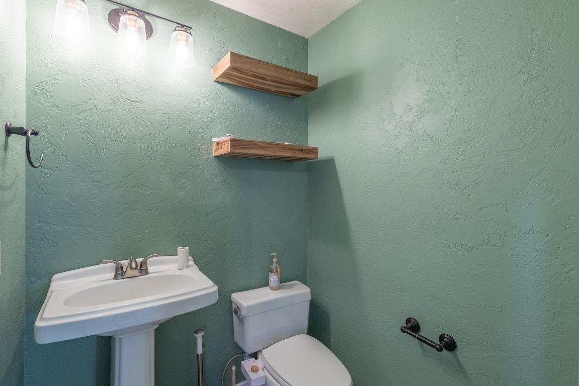 8514 Racine Trail Austin, TX 78717 - Photo 24 of 33 Bathroom featuring a textured wall and toilet