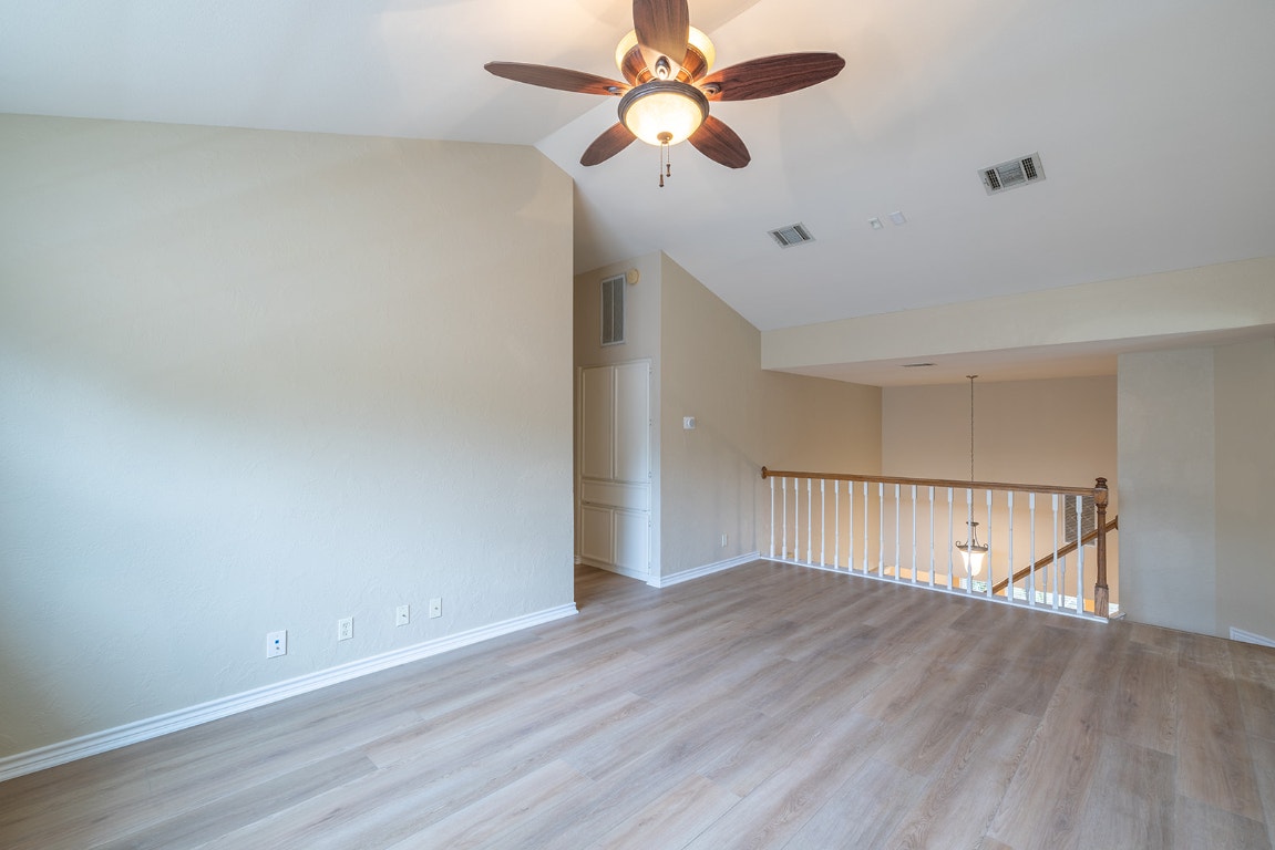 8514 Racine Trail Austin, TX 78717 - Photo 26 of 33 Spare room with ceiling fan, light wood finished floors, and vaulted ceiling