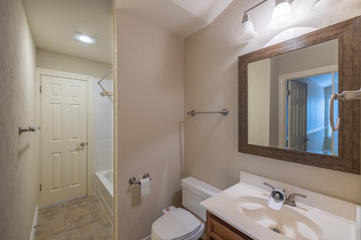 8514 Racine Trail Austin, TX 78717 - Photo 29 of 33 Bathroom with vanity, shower combination, and a textured wall
