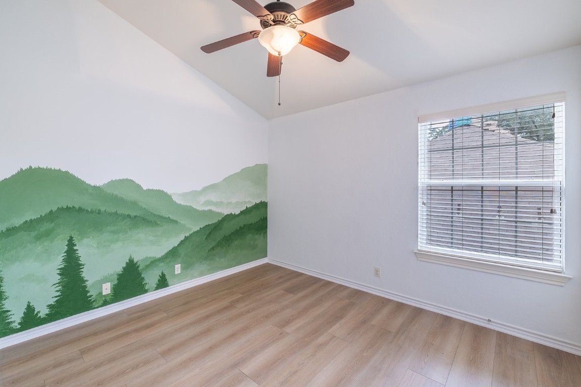 8514 Racine Trail Austin, TX 78717 - Photo 30 of 33 Spare room featuring light wood-type flooring, lofted ceiling, and a ceiling fan