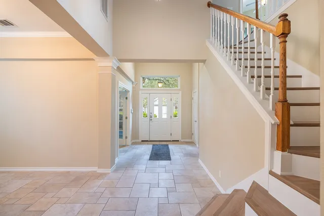 a view of a hallway with wooden floor and entryway