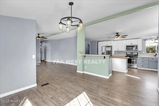 a view of a kitchen with microwave and cabinets