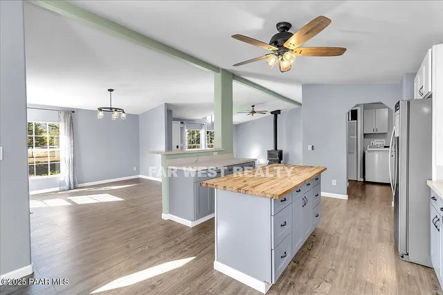 a kitchen with stainless steel appliances granite countertop a stove and a refrigerator