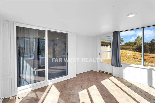 a spacious bedroom with a large window and a balcony