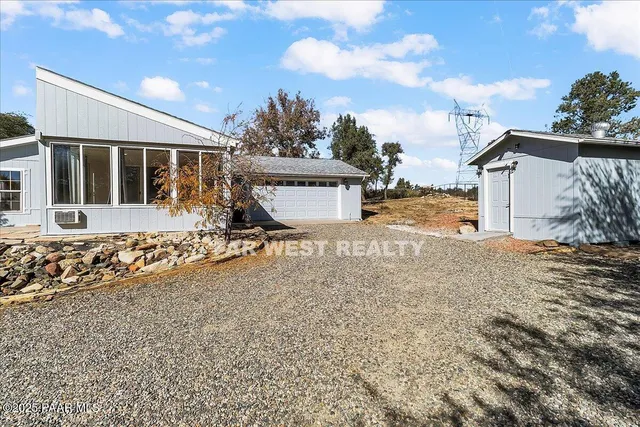 a view of a house with wooden fence
