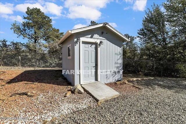 a wooden bench sitting in front of a house